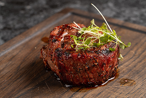 In Room Dining filet mignon on a wooden board