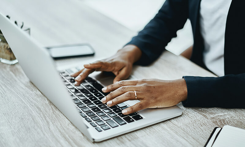 Person connecting to Wi-Fi on a laptop keyboard