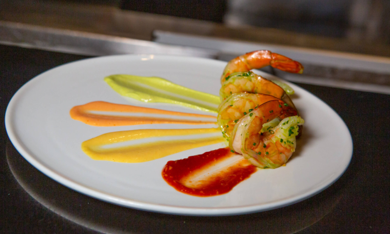 Plate with shrimps and four different sauces from Bluezoo restaurant.